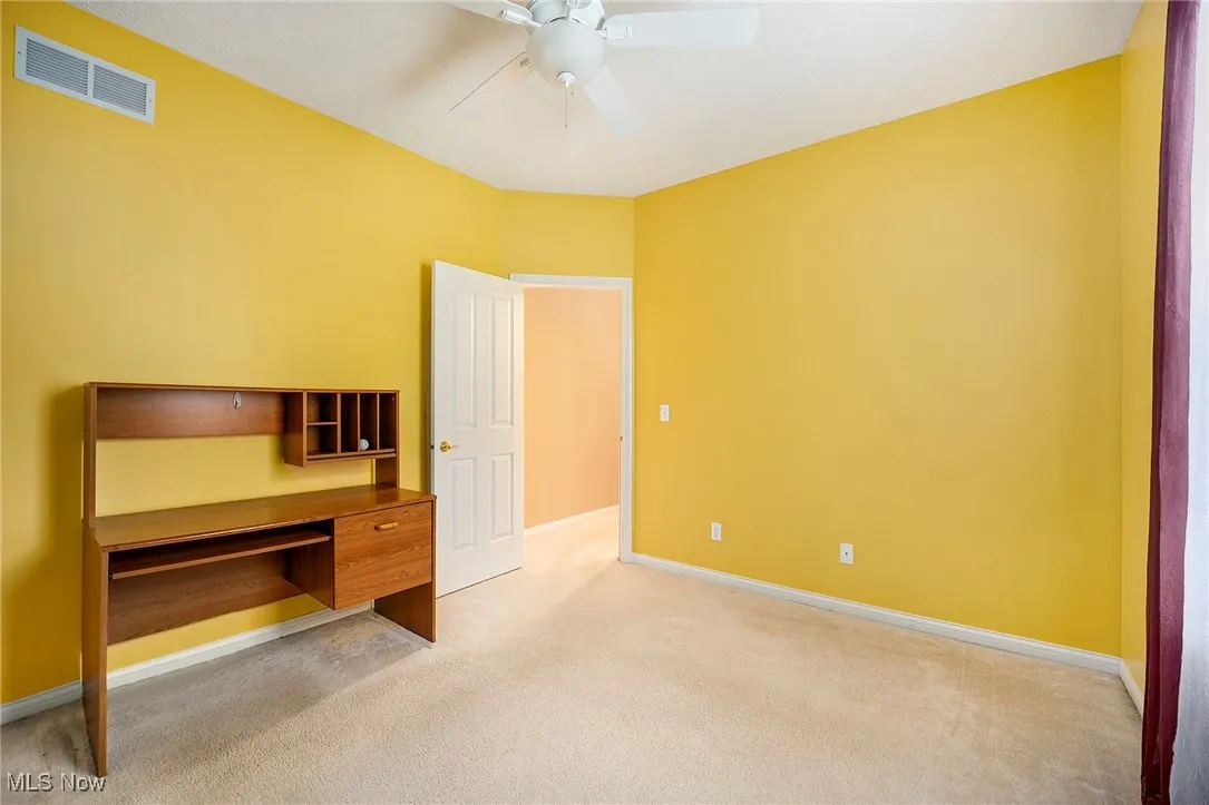 Unfurnished bedroom featuring light colored carpet and a ceiling fan