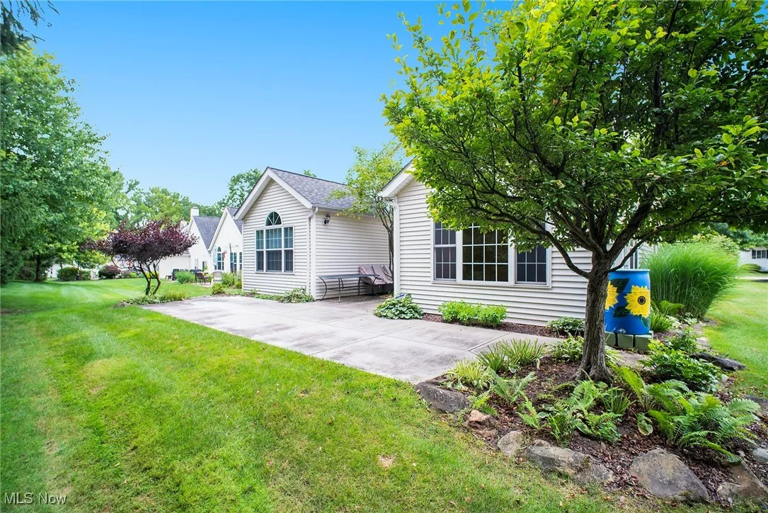 Rear view of property with a yard and a patio area