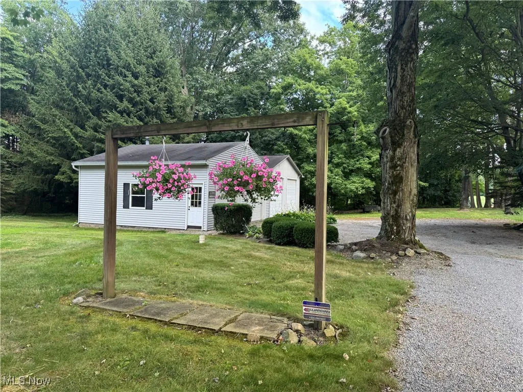 View of backyard featuring 2 outbuildings and a yard