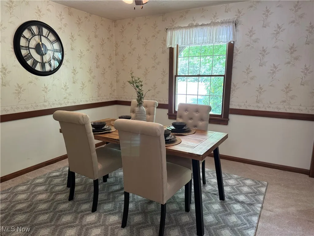 Dining room with carpet flooring and ceiling fan
