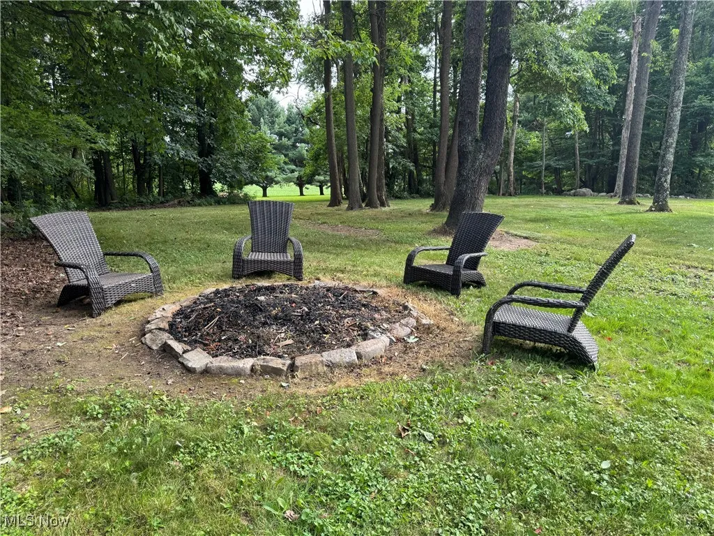 View of green lawn with a fire pit