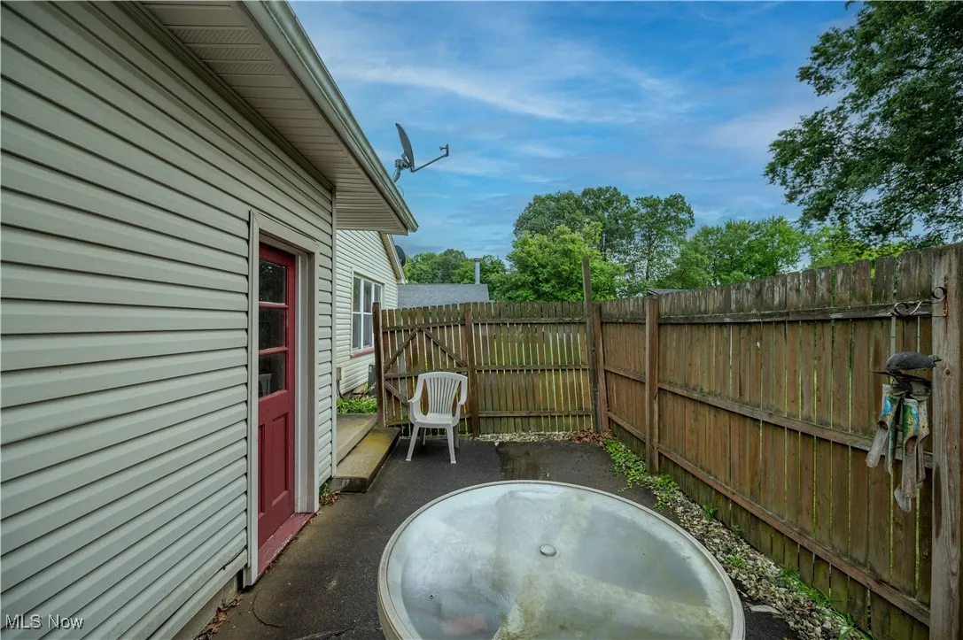 Backyard featuring a private fenced in patio area with gate access to rest of yard