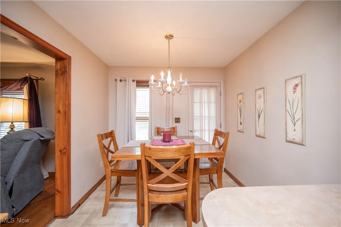 Eat-in Kitchen with a chandelier and baseboards