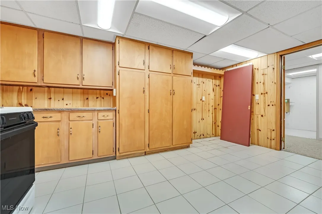 Gas range, pantry, cabinets, countertops, and room for a full-size refrigerator in this room