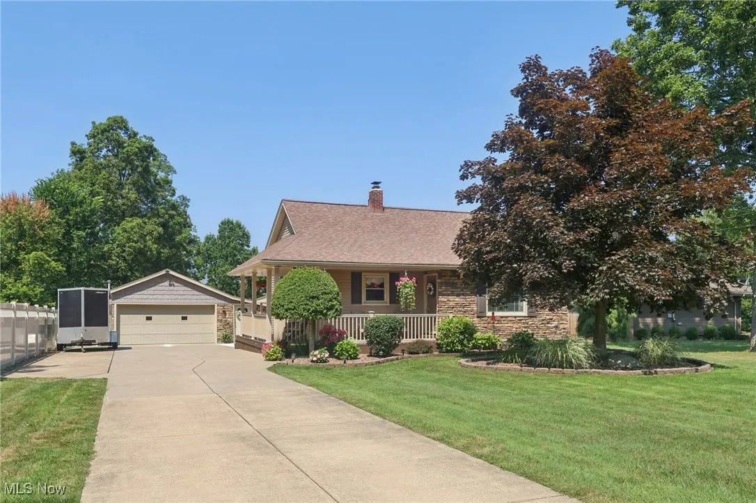 The well maintained home with everything practically new has all to be desired in a home.  Stone accents and vinyl siding.  A covered wrap around porch with composite flooring and vinyl rails.  Landscaping is meticulous!!
2 Car garage and a carport off the back of the home.