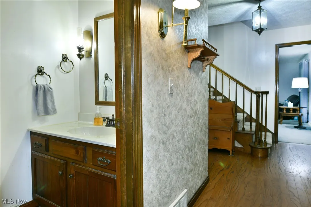 Bathroom with wood finished floors and vanity