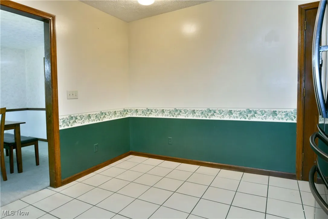 Unfurnished room with a textured ceiling