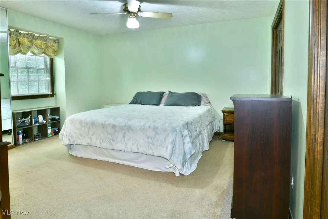 Bedroom with carpet flooring and ceiling fan
