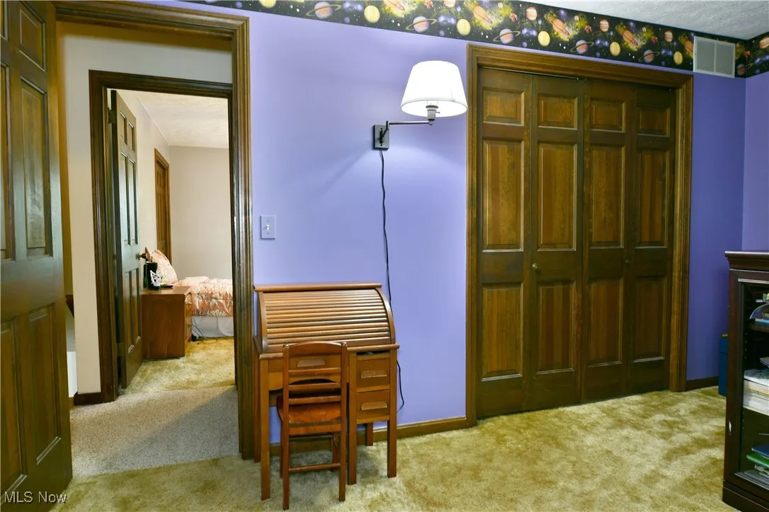 Bedroom featuring carpet and a closet