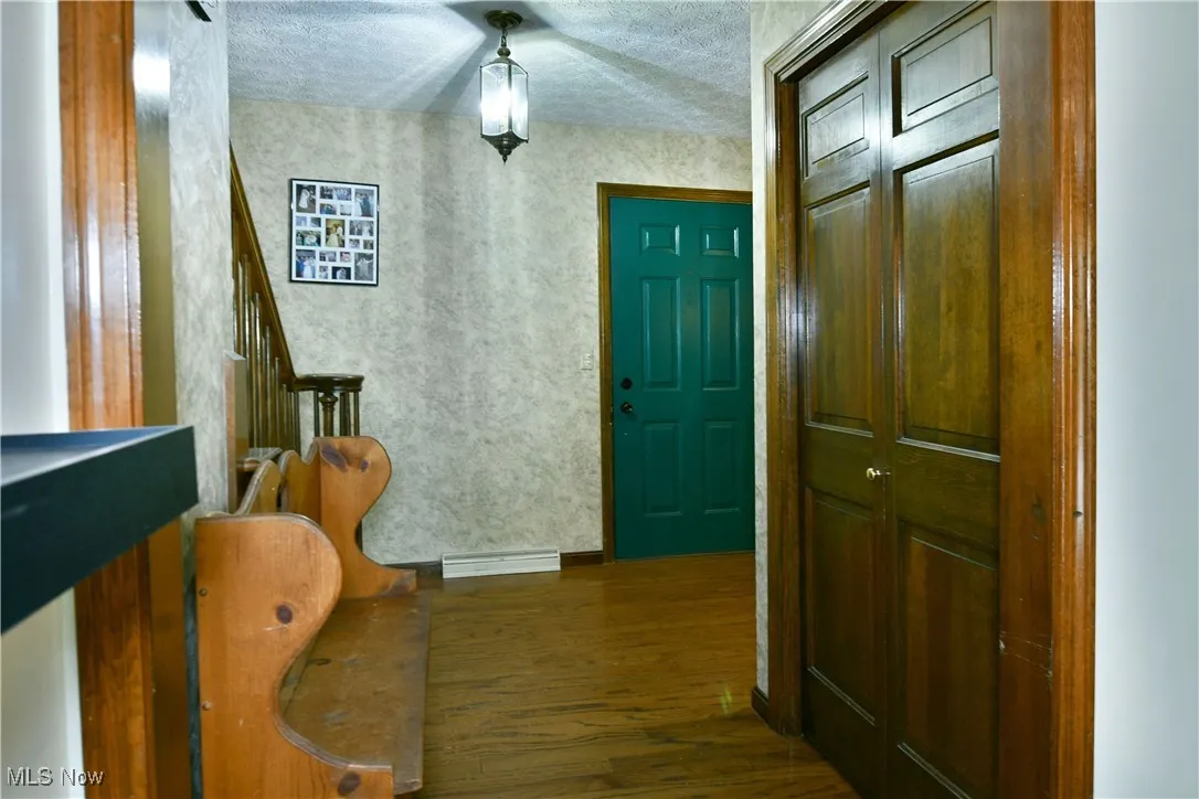 Entryway with wood finished floors and a textured ceiling