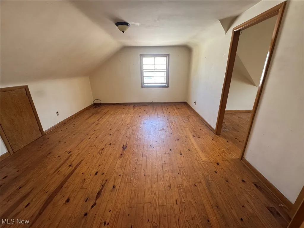 Bonus room featuring vaulted ceiling and light wood finished floors