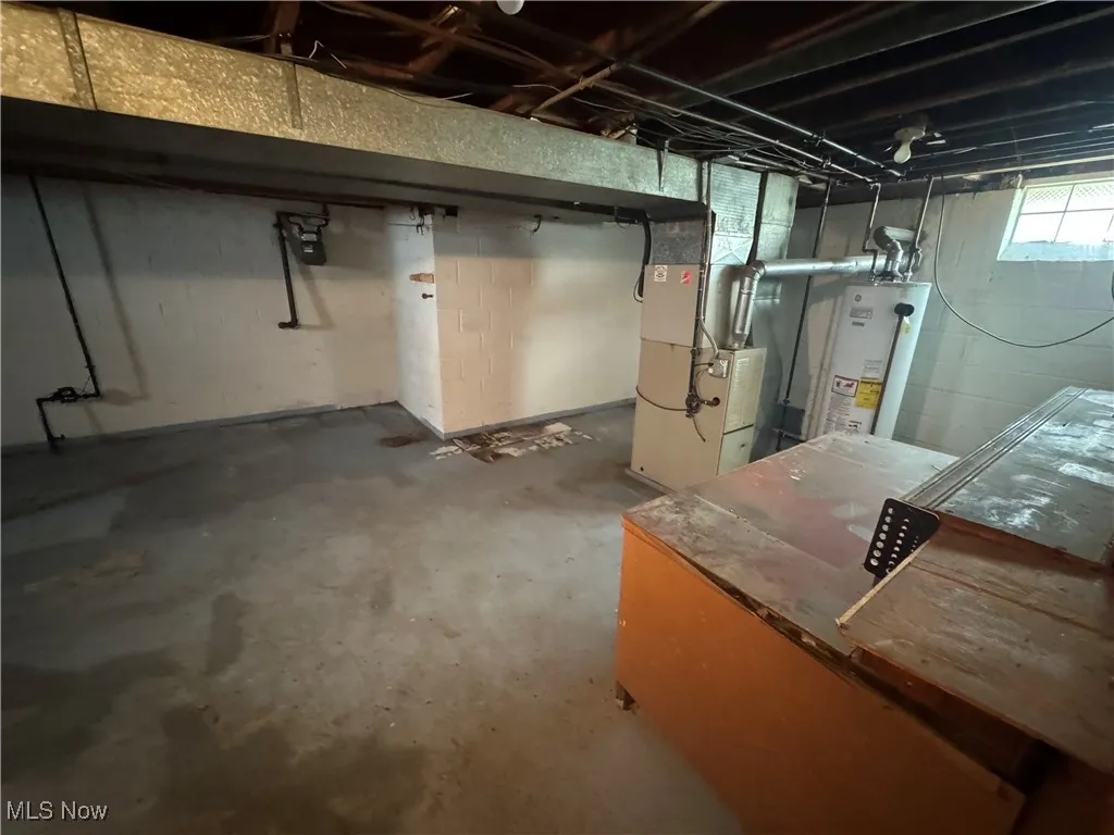 Below grade area with heating unit and gas water heater