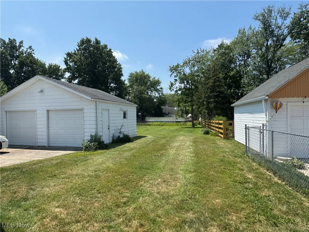 View of yard with an outbuilding and a garage