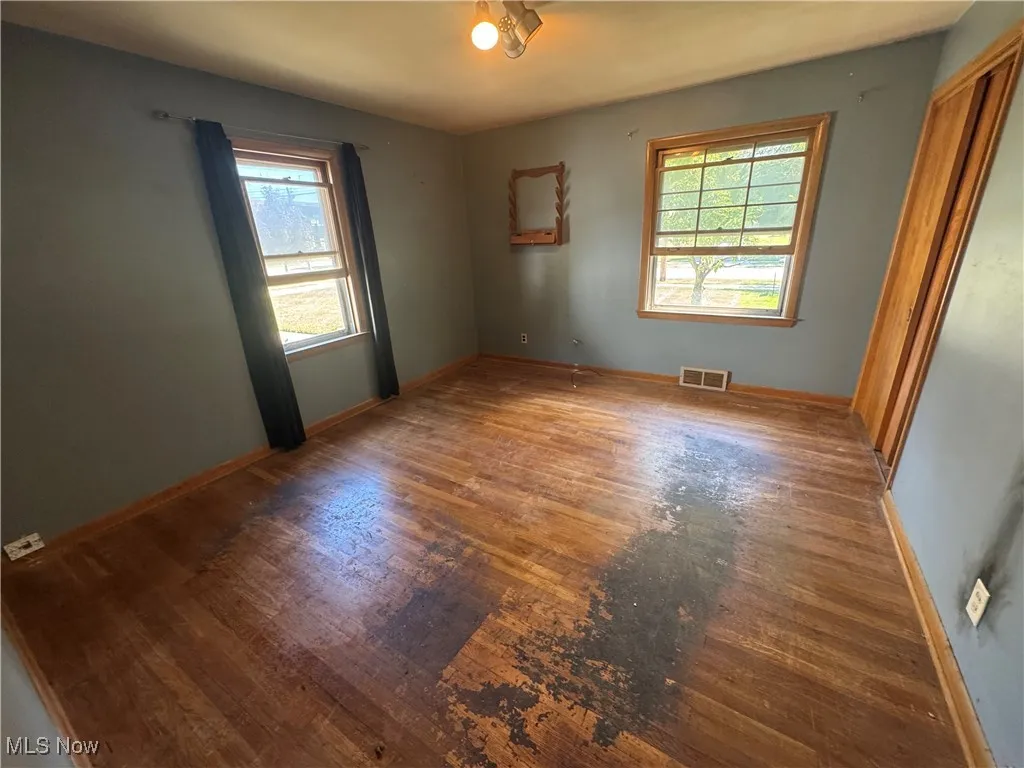 Empty room featuring wood finished floors and baseboards