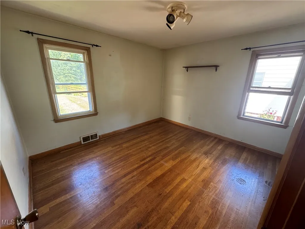 Spare room with wood finished floors and baseboards