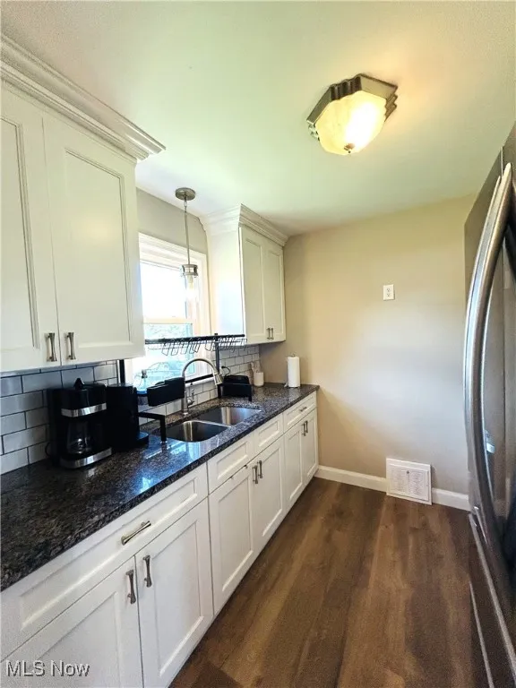 Kitchen featuring refrigerator and cabinets