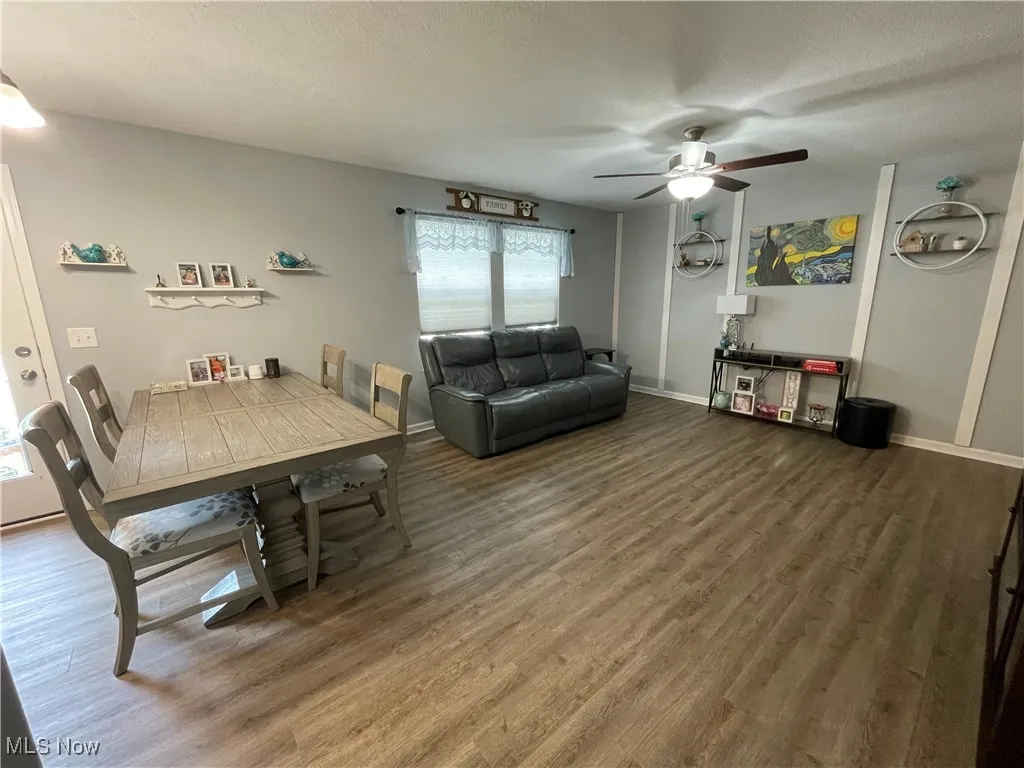 Dining room featuring wood finished floors and a ceiling fan