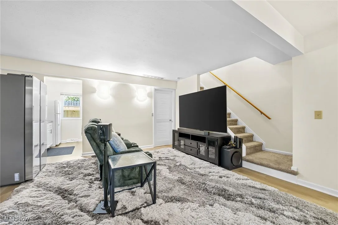 Living area featuring stairs and wood finished floors