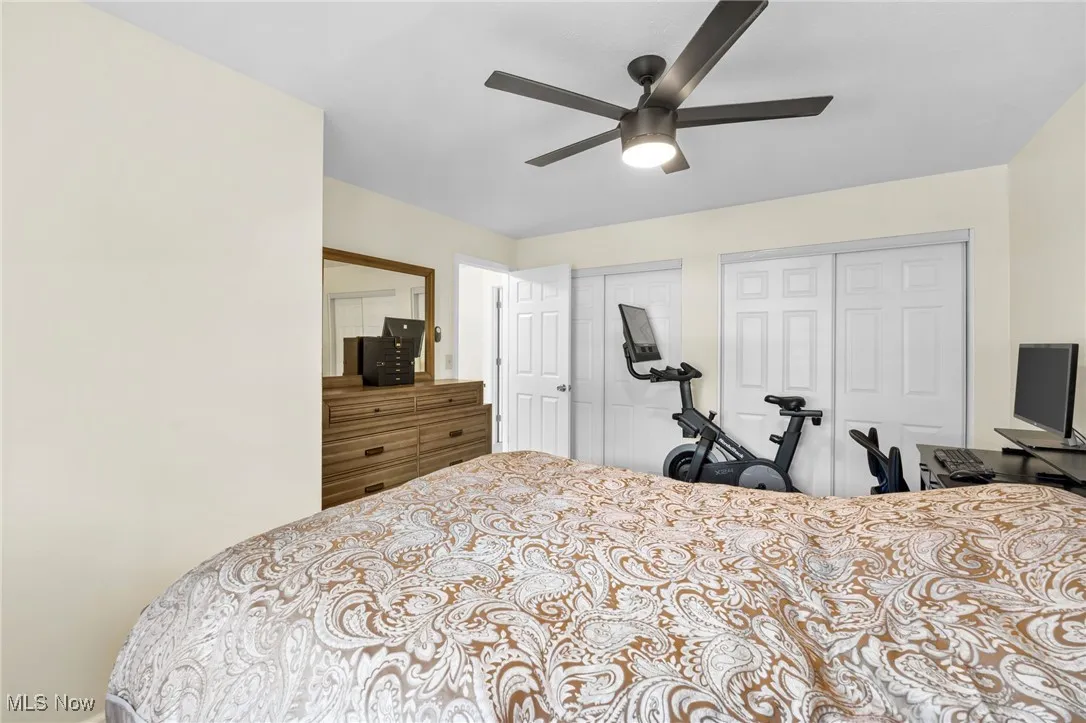 Bedroom featuring multiple closets and a ceiling fan
