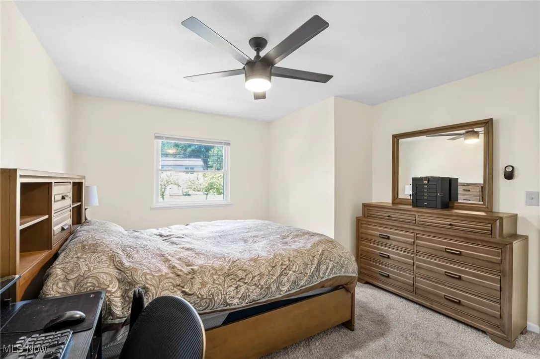 Bedroom featuring light colored carpet and a ceiling fan
