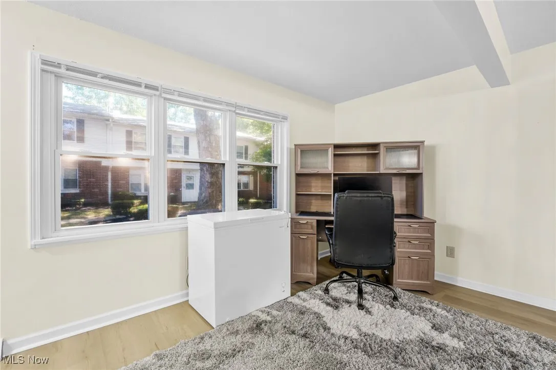 Office space featuring healthy amount of natural light and wood finished floors