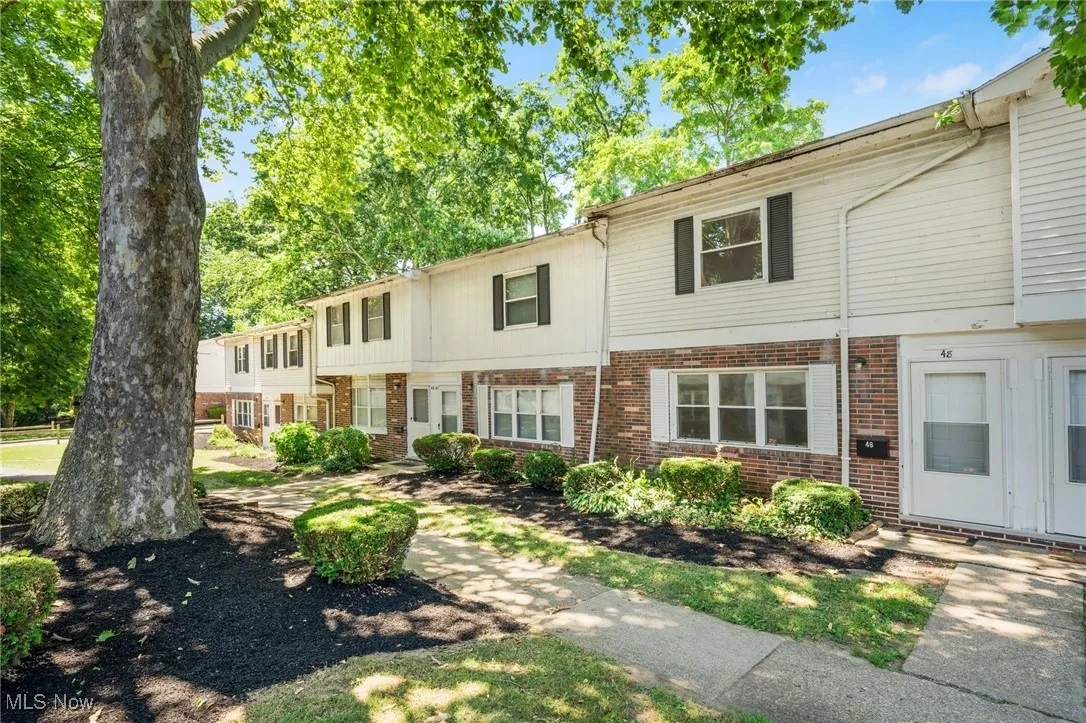 Colonial-style house with brick siding