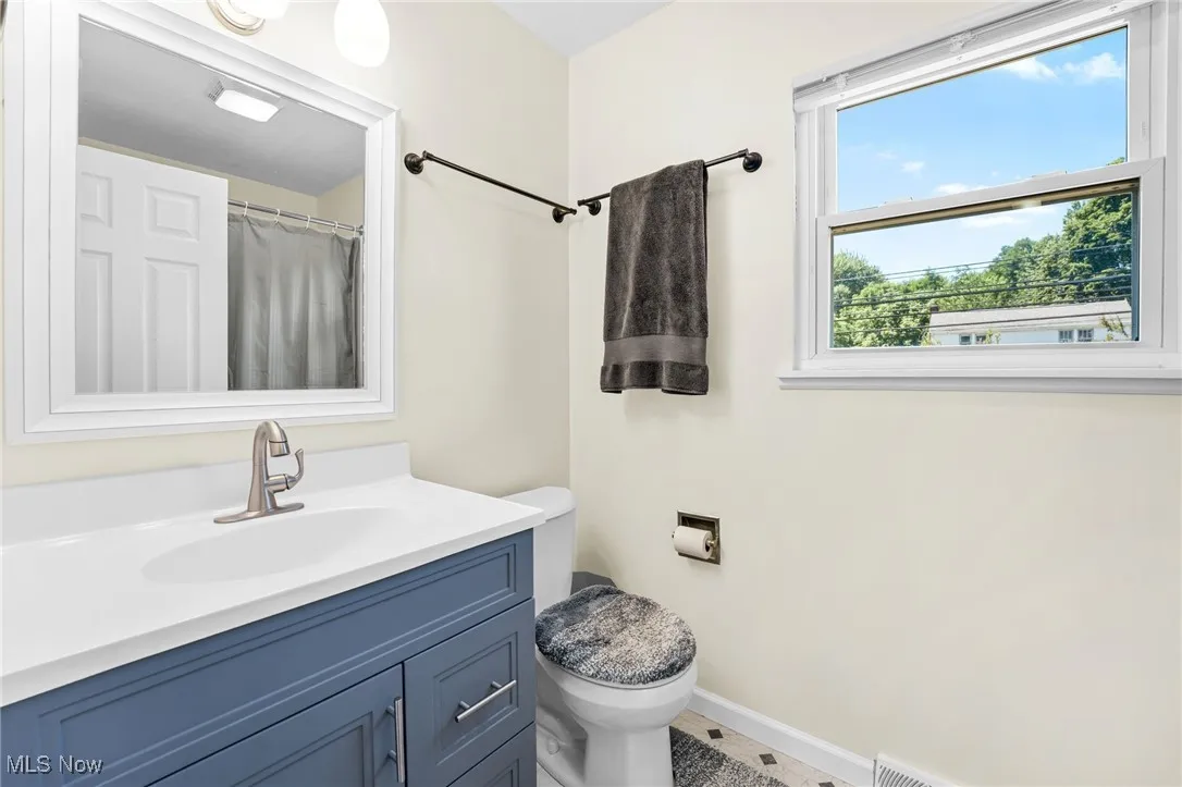 Full bathroom featuring vanity and toilet