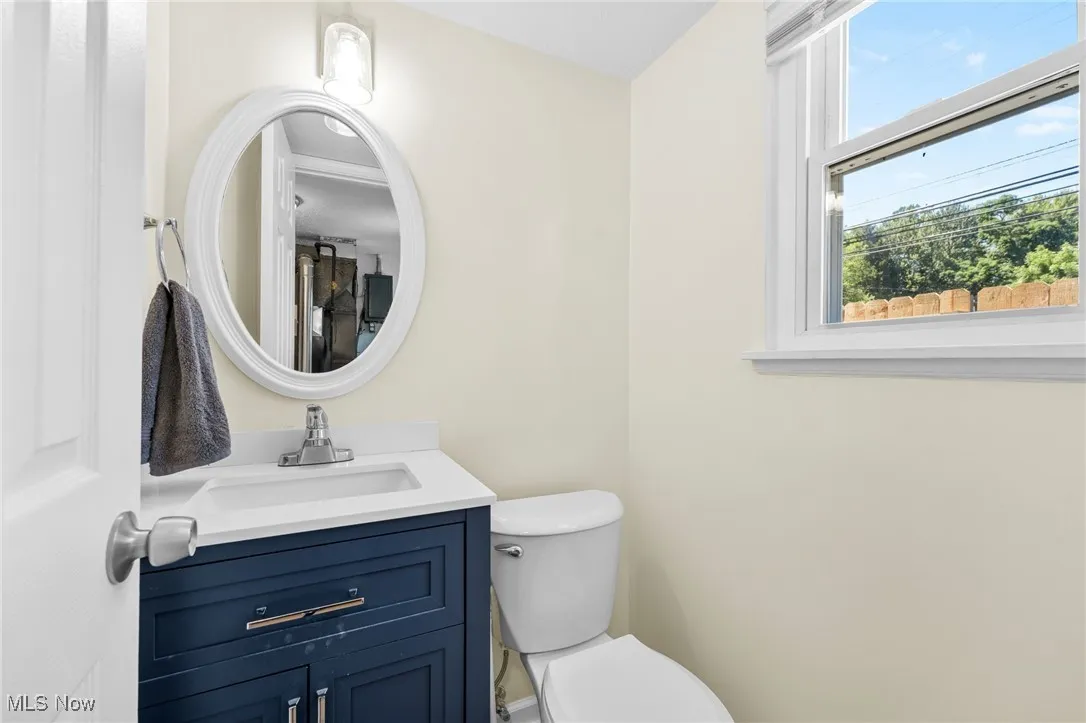 Half bathroom with toilet and vanity