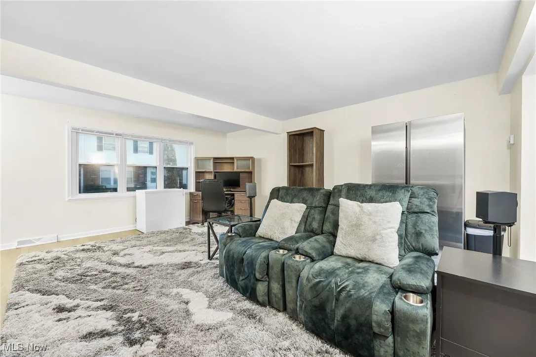 Living room with baseboards and a desk