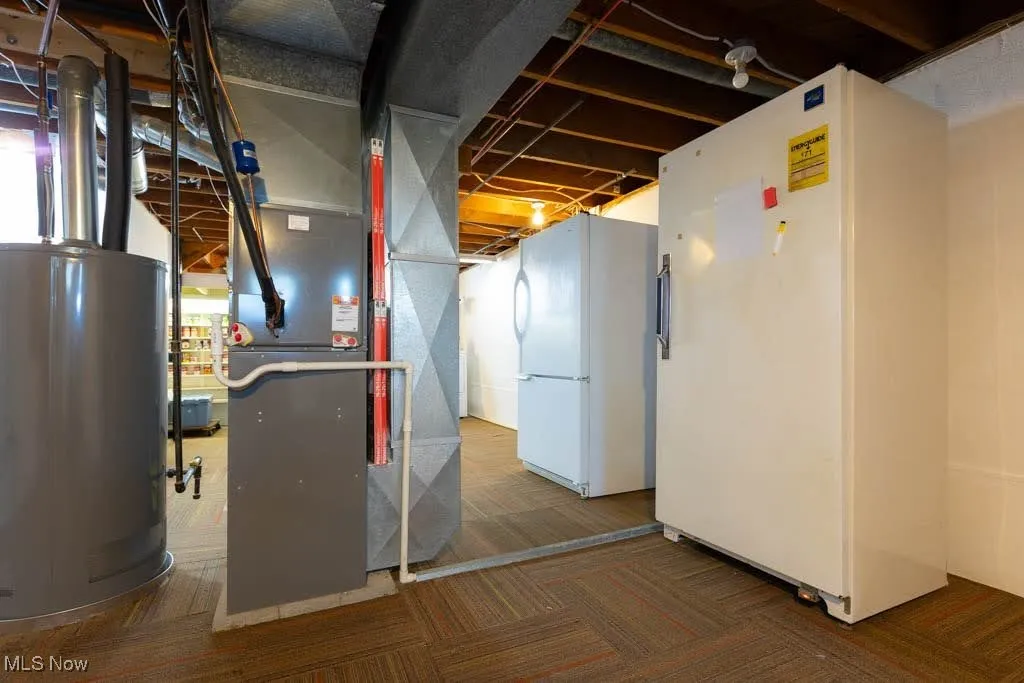 Utility room with water heater and heating unit