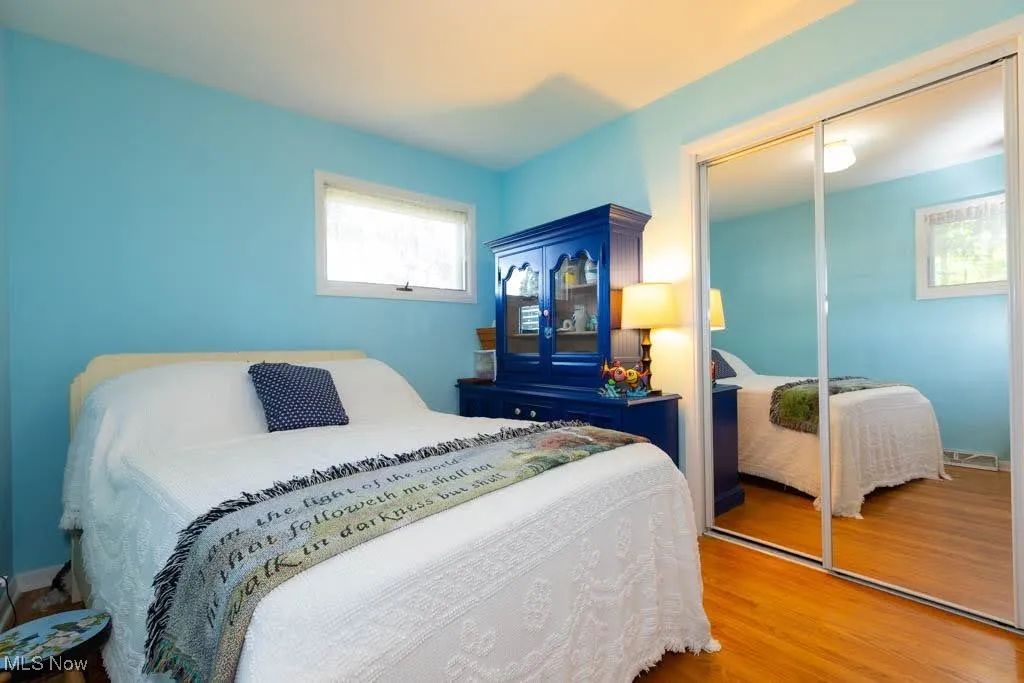 Bedroom with a closet and wood finished floors