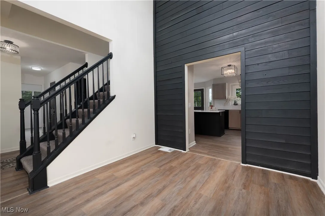 Stairs with wood finished floors and wood walls