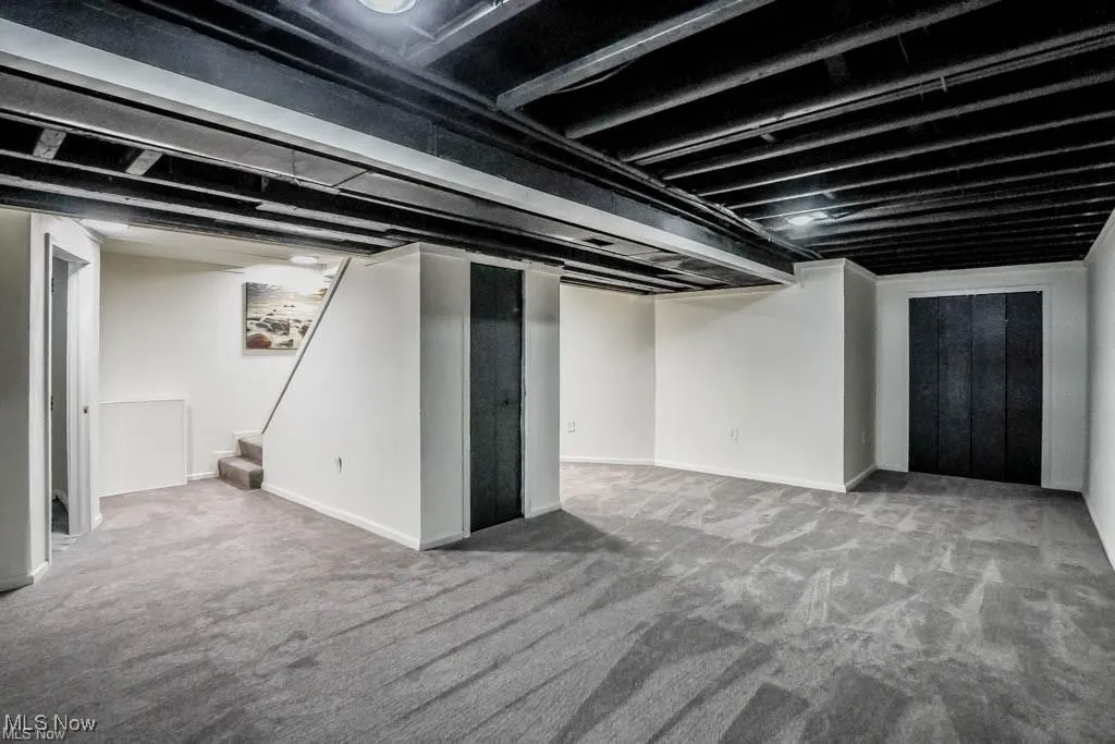 Finished below grade area featuring carpet flooring and stairway