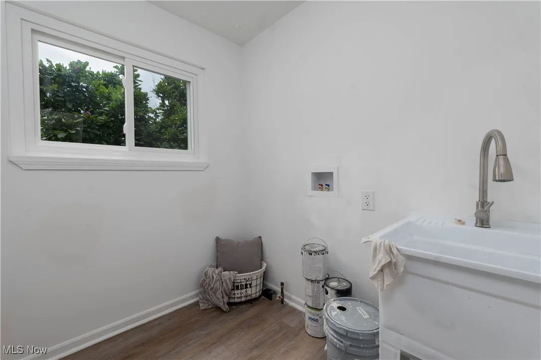 1st Floor Laundry Room featuring hookup for a washing machine and Vinyl Laminate finished floors