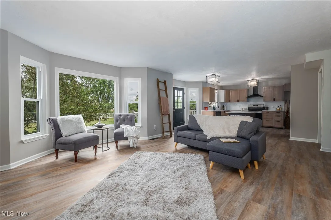 Living area with plenty of natural light and wood finished floors