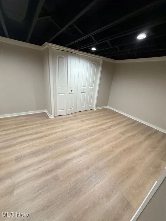 Finished basement featuring light wood-type flooring and baseboards