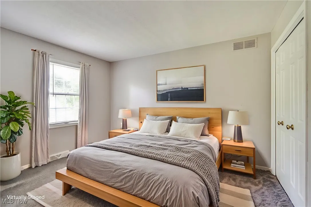Carpeted bedroom featuring baseboards and a closet
