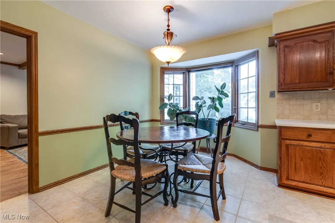 Dining room featuring baseboards and light tile patterned flooring