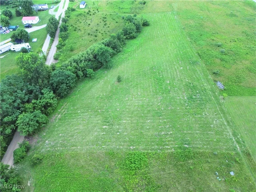 Aerial view of property and surrounding area featuring rural landscape