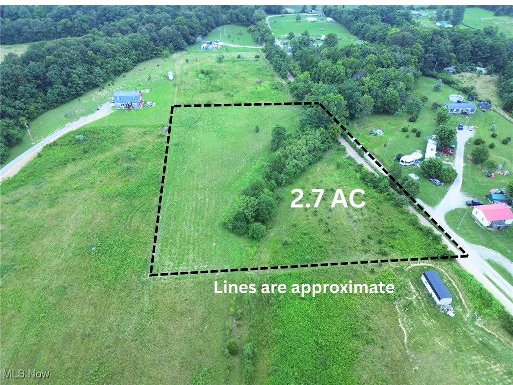 Aerial view of sparsely populated area with property parcel outlined