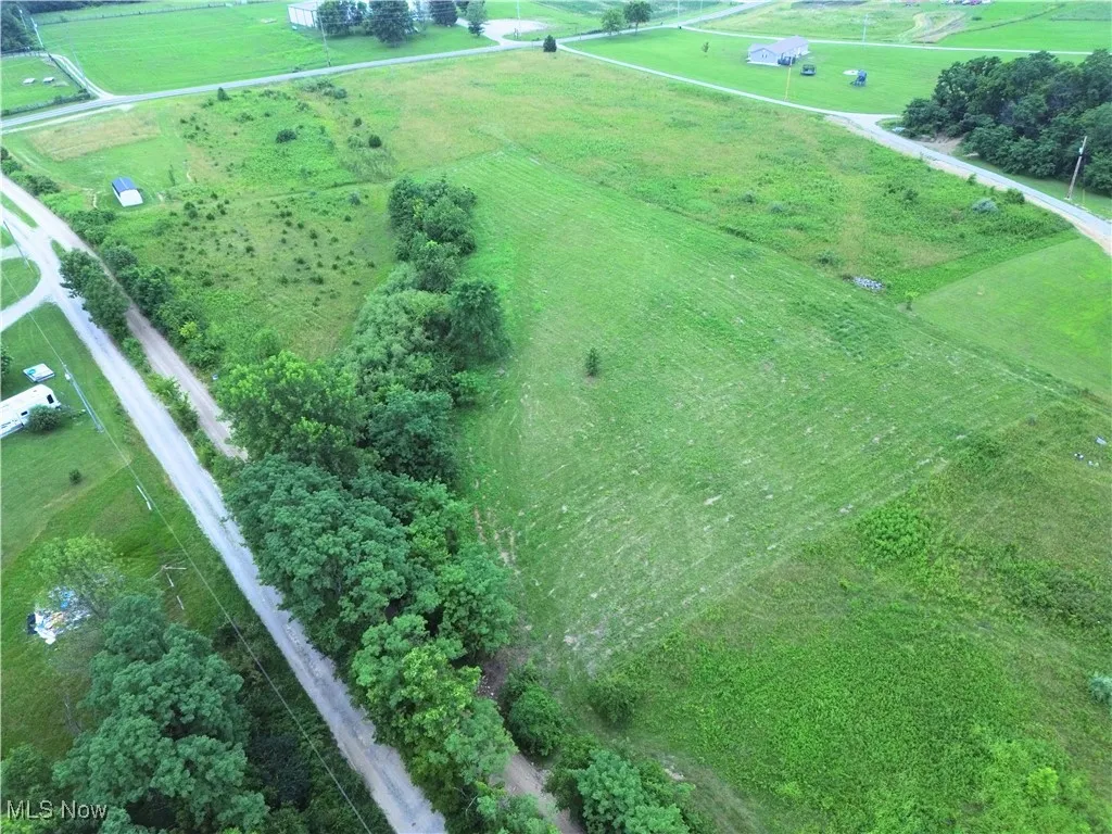 Aerial view of property and surrounding area featuring rural landscape