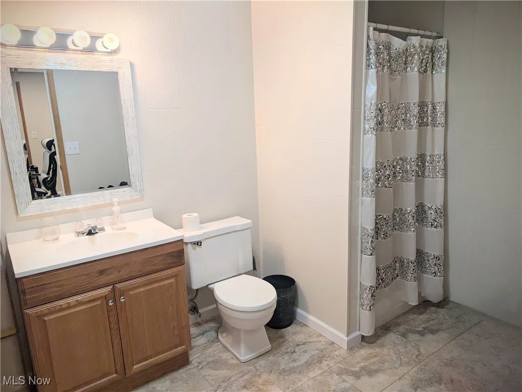 Full bathroom featuring vanity and a shower with curtain