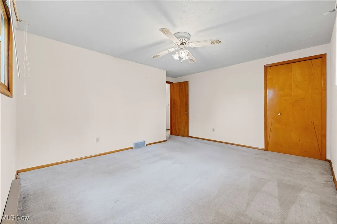 Bedroom featuring a ceiling fan and closet