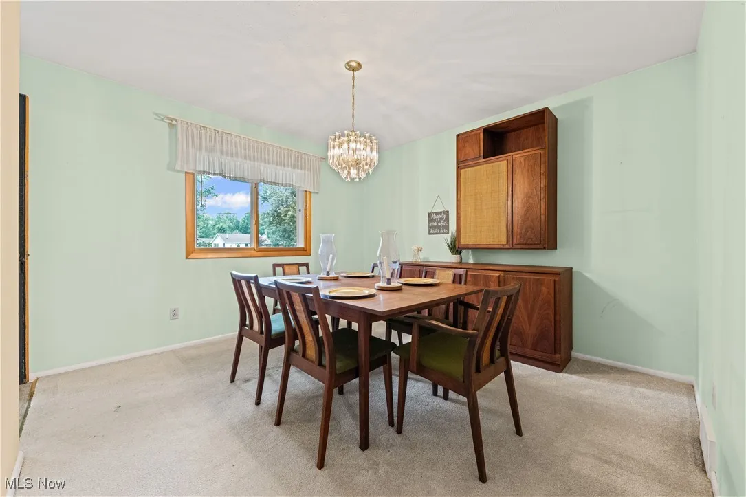 Dining room with dining table, built-in cabinet and a chandelier