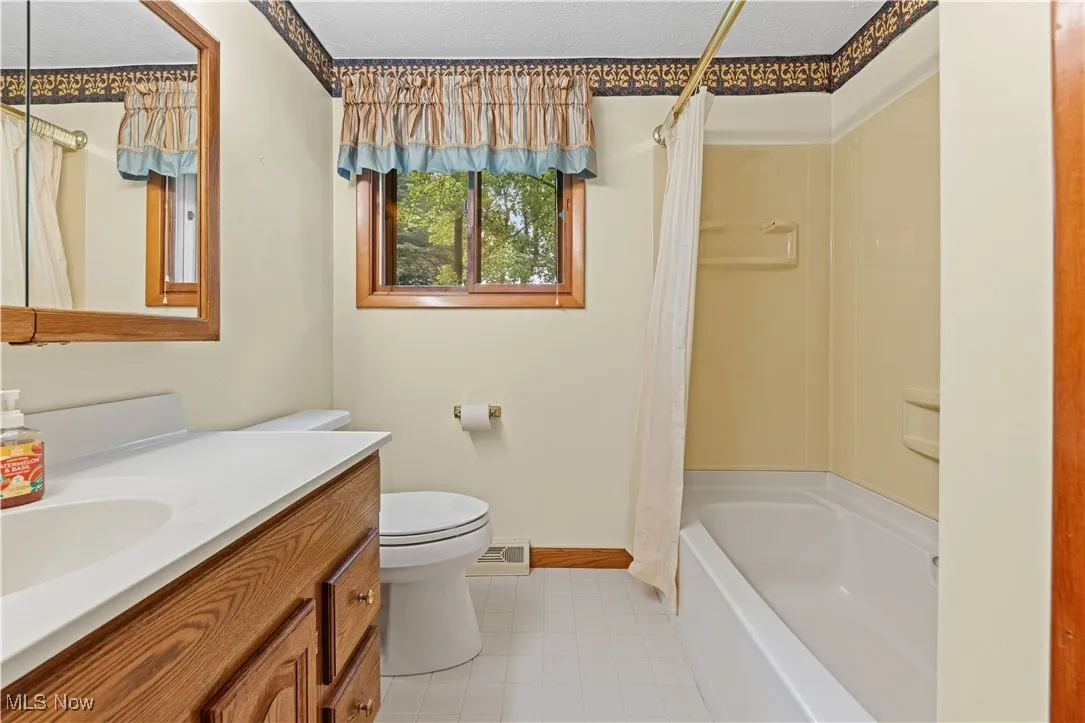 Bathroom featuring vanity and shower / bath combination