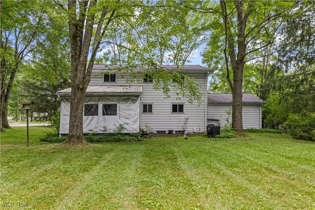 Rear view of property featuring a yard
