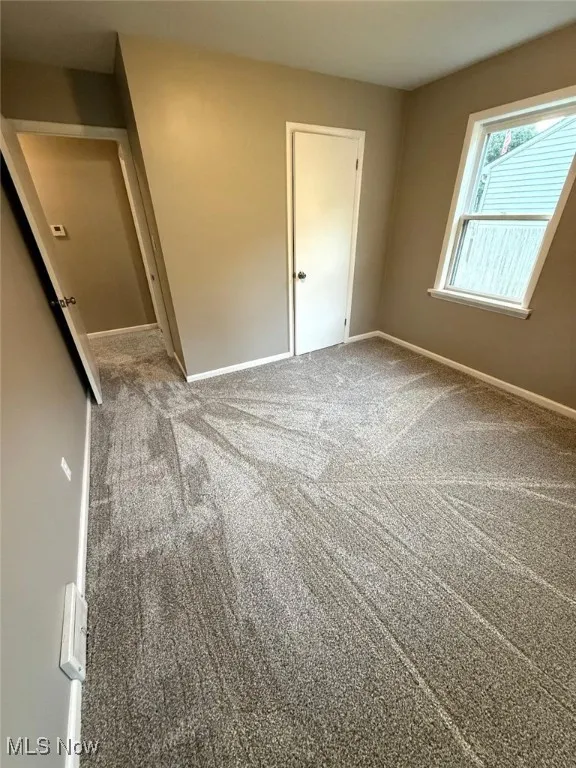 Spare room with carpet flooring and baseboards
