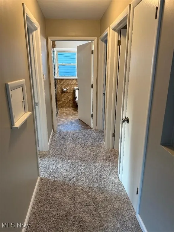 Corridor featuring carpet floors