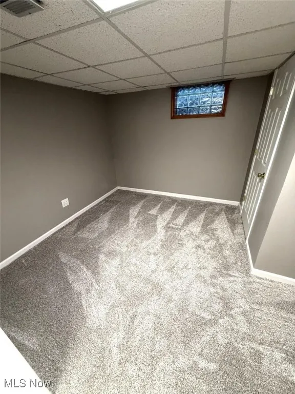 Finished basement featuring carpet and a drop ceiling
