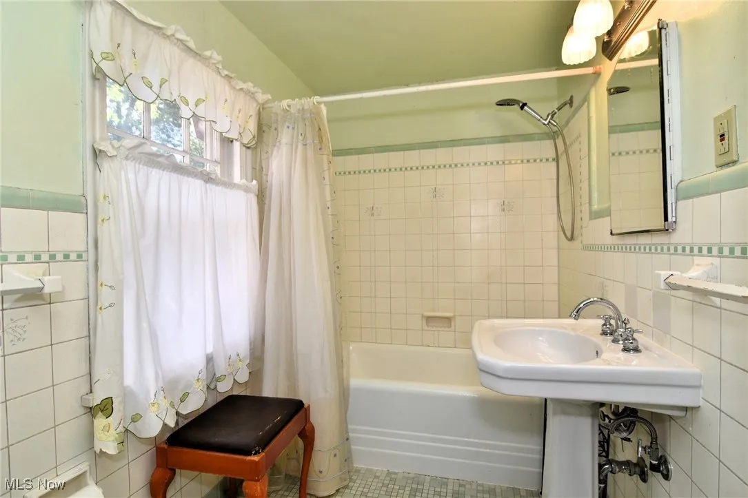 Full bath with tile walls and shower / tub combo 2nd floor